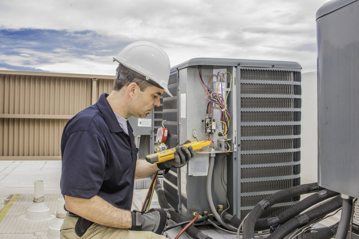 Why You Should Hire a Professional HVAC Technician. HVAC technician working on an outdoor unit